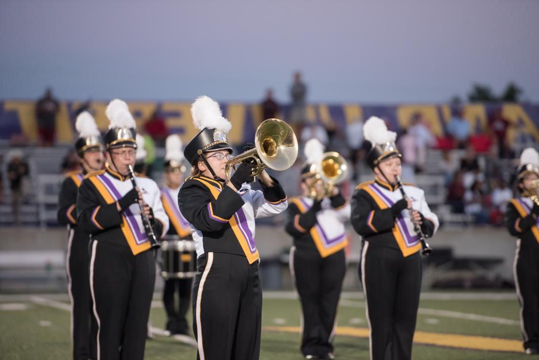 Members of the AU Marching Band performing during a football game