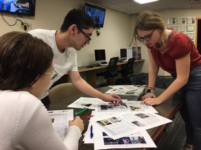 Collegian editors looking over proofs for the next issue